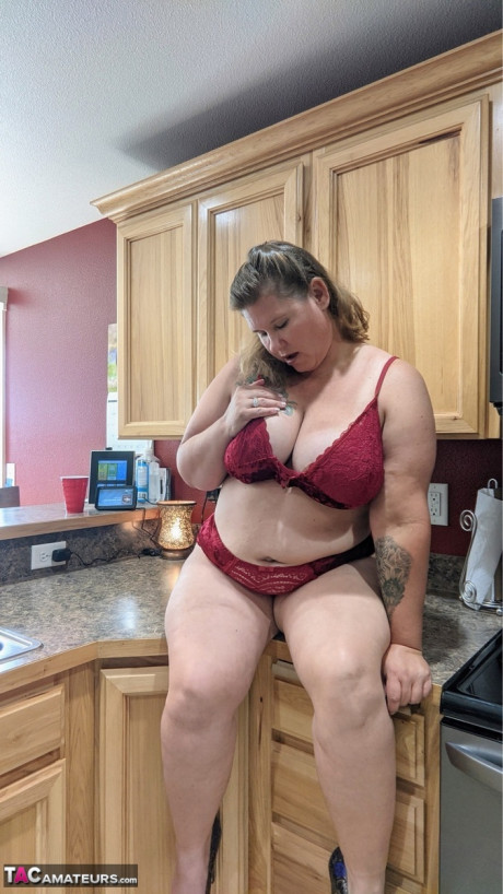 Amateur girl Busty Kris Ann shows her giant melons and butt in her kitchenette