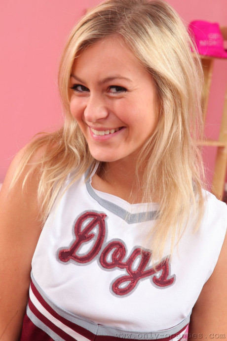 Cheerleader Summer exposes her great boobies while posing in tights on the bed