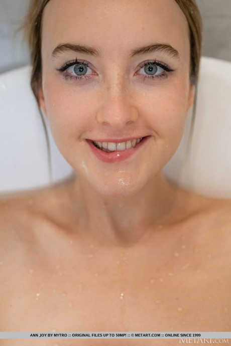 Blondie teen Ann Joy splashes water on her natural titties in a bathtub - #830611