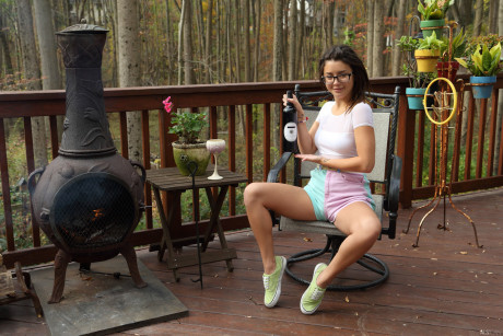 Smiley teenie Daisy Haze inserts a wine bottle into her pegged snatch outdoors - #566310