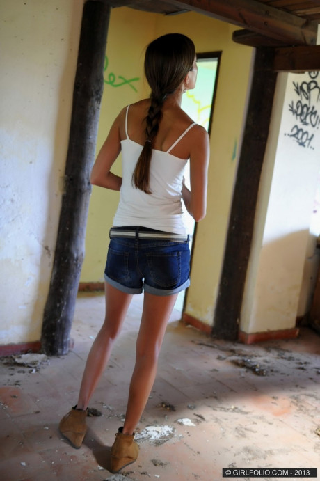 Skinny chick lady takes off her denim shorts to pose undressed against graffiti - #174981