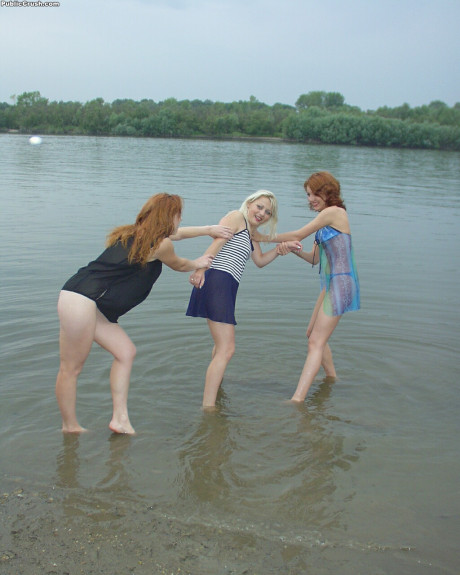 Young sluts partially remove wet clothing after wading into a river - #216385
