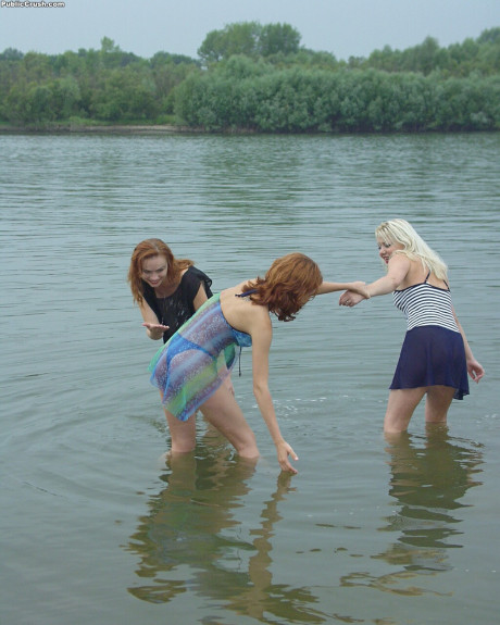 Young sluts partially remove wet clothing after wading into a river - #216387
